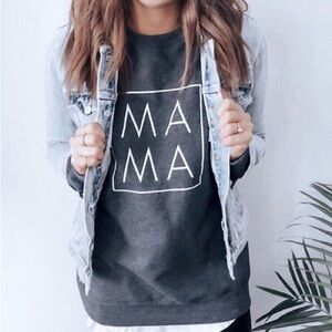 Ashco. The MAMA Label white long sweater with black logo. Small stain on the arm